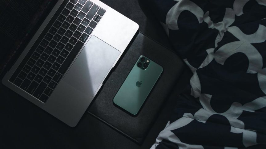 photo of laptop beside smartphone